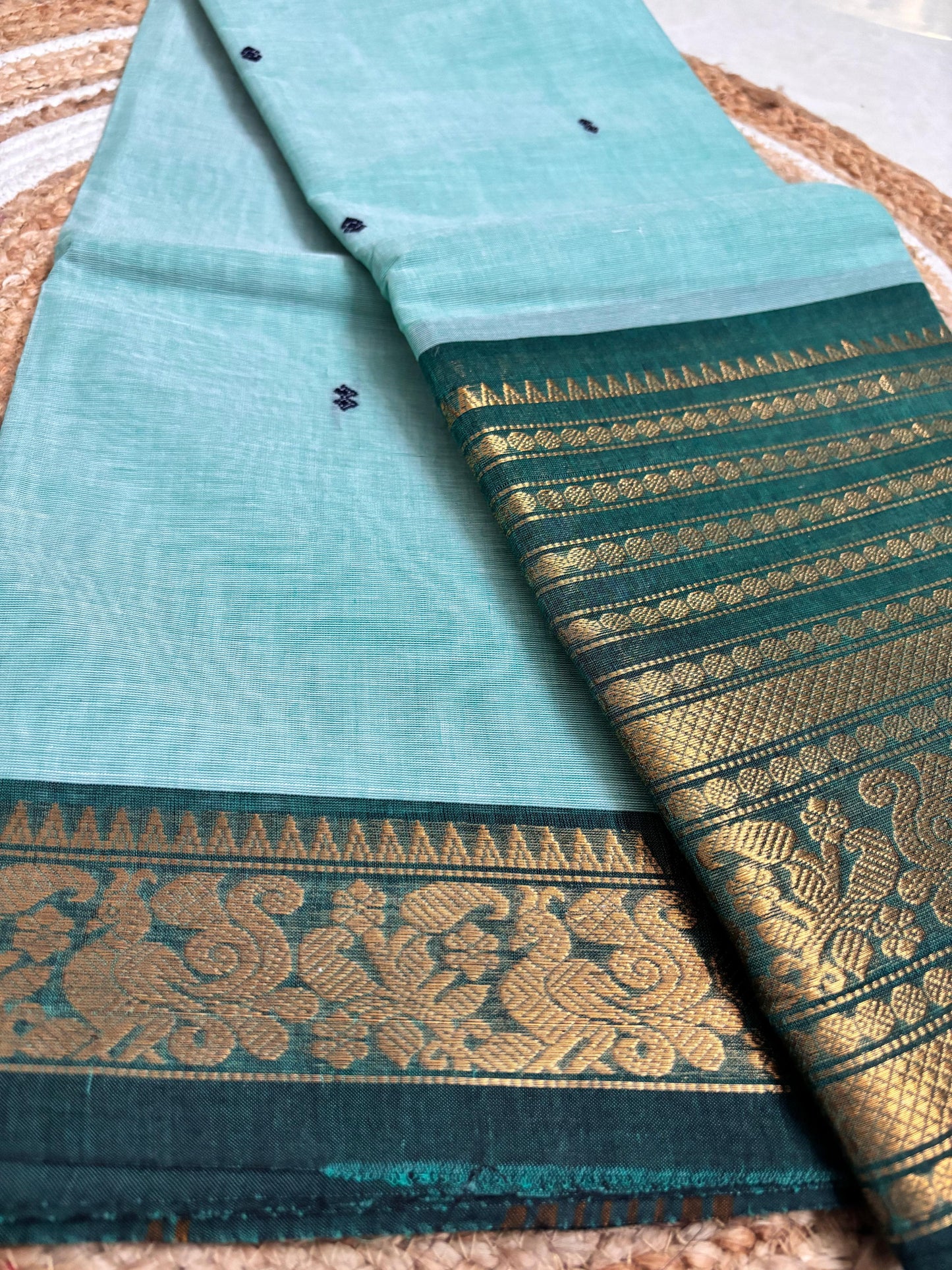 Nira-  Pastel blue Kanchi cotton saree with a contrasting bottle-green border