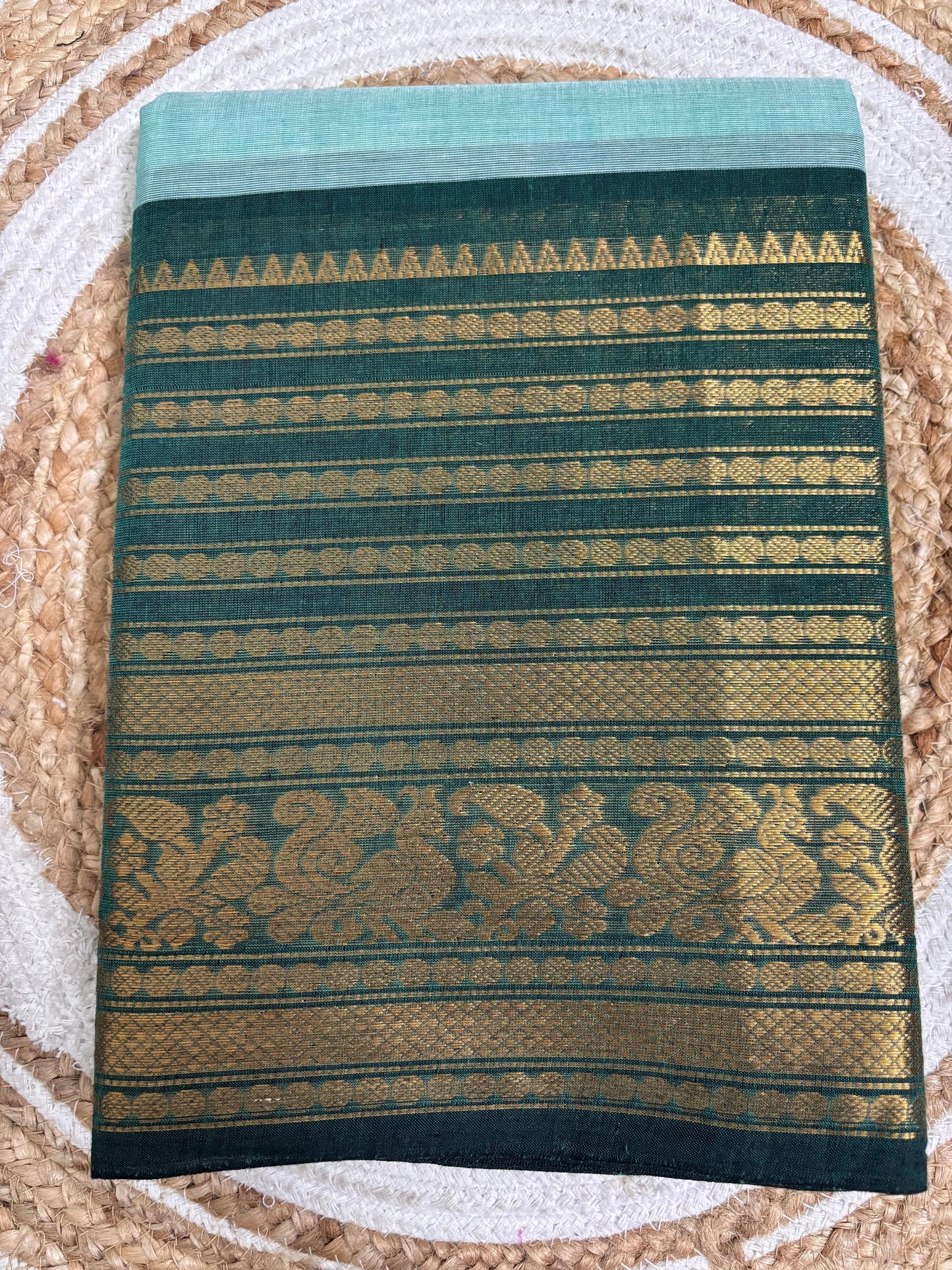 Nira-  Pastel blue Kanchi cotton saree with a contrasting bottle-green border