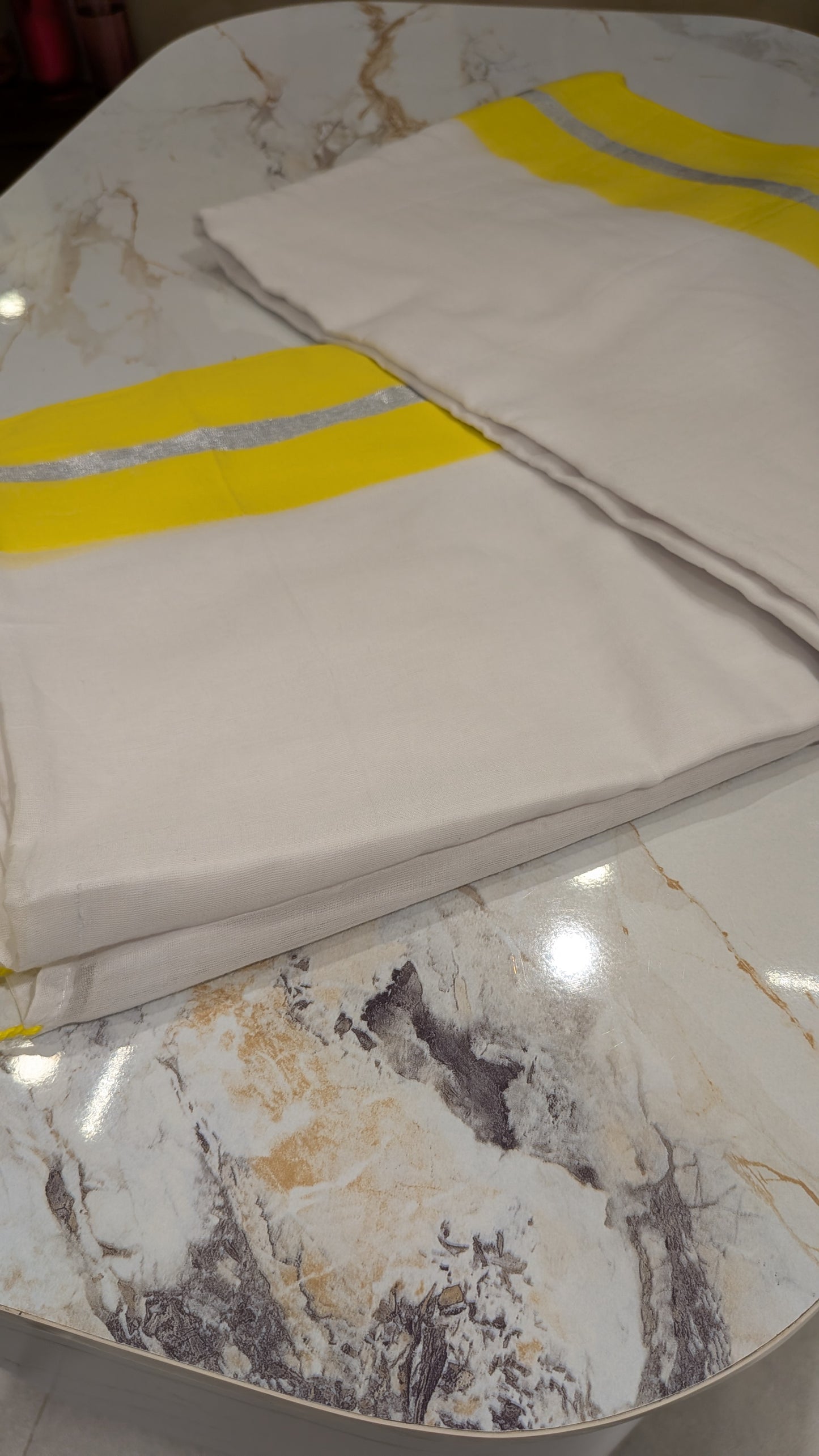 Mridula - Yellow and Silver Border white Mulmul saree